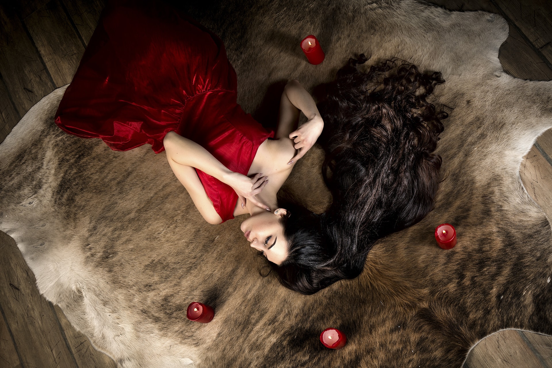 woman red dress laying down animal fur